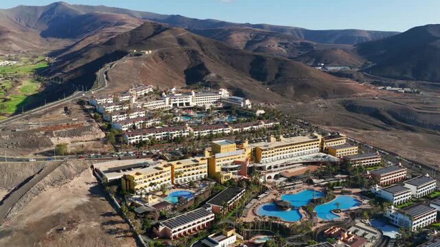Aerial view of luxury beachfront resort architecture, swimming pools and sun loungers in Morro Jable Fuerteventura