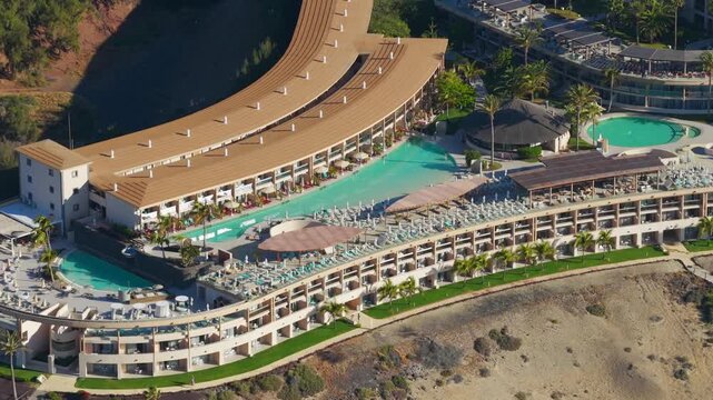Aerial view of luxury beachfront resort architecture, swimming pools and sun loungers in Morro Jable Fuerteventura