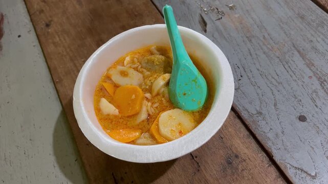 Close up of Seblak Indonesian spicy street food in styrofoam bowl