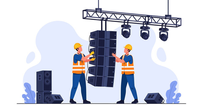 Two technicians installing a large speaker array for a concert event.