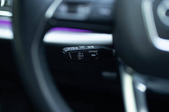 Cruise control button on a new electric vehicle. The cruise control knob on a modern car. Automotive cruise control system of the car with speedometer lock indicator. Cruise control tempomat lever