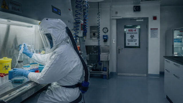 Ebola virus, biosafety,level, laboratory. Scientist in full protective suit working inside high-security laboratory,