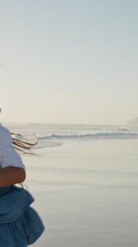 Running, face or playing with girl on beach for summer holiday, vacation or outdoor weekend. Playful, child or kid with smile on ocean coast or sea for freedom, happy childhood or adventure in nature