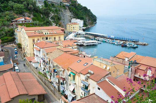 Aerial view of Marina Grande harbor in Sorrento, Italy, on cloudy overcast weather. This Sorrento location features charming Mediterranean seaside architecture