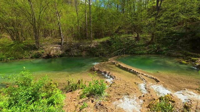 Crystal-clear water cascades over mossy rocks. Bigar Waterfall, Stara Planina. (Balkan Mountains), Serbia.
