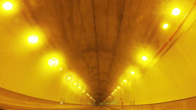 Driving through a dimly lit urban tunnel
