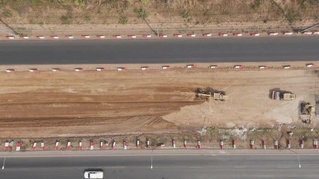 Drone footage a construction working tractor is refining the soil in preparation for laying asphalt The process of making a highway
