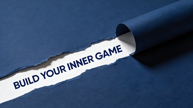 Motivational quote about building your inner game revealed underneath a layer of torn dark blue paper in this professional studio photograph showing a conceptual business message