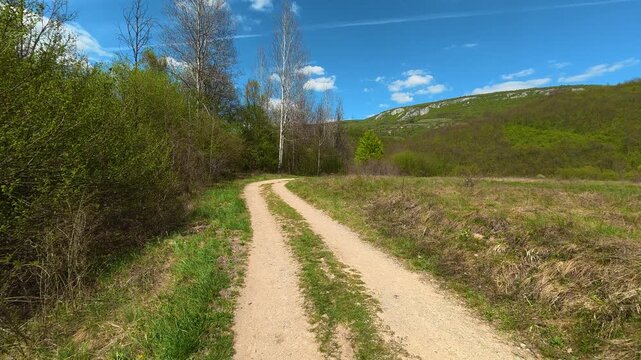 Sunlit path winds through green hills. Bigar Waterfall, Stara Planina. (Balkan Mountains), Serbia.