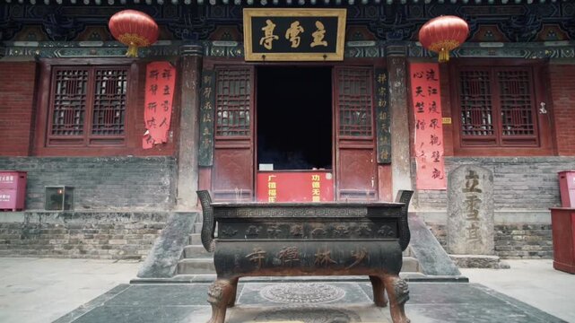 Pagoda Forest at Shaolin Temple in China, Asia, showing ancient stone pagodas surrounded by green mountains and forest landscape in serene atmosphere