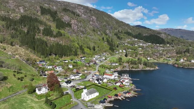 Bruvik village on Osteroy by Sorfjorden Norway during sunny spring day with fjord landscape
