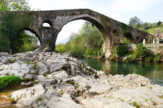The Roman bridge over The Sella river as it passes through Cangas de Onis town, Asturias, Spain