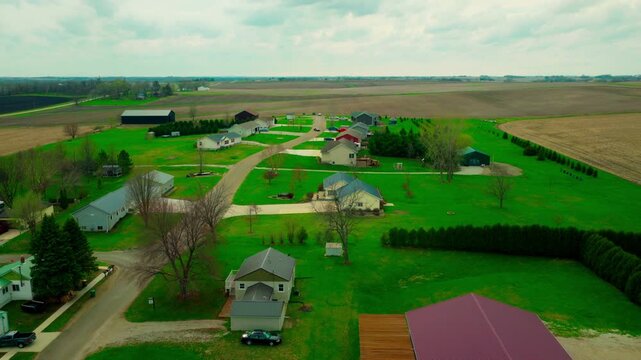 Quiet residential neighborhood in Brandon, Iowa, showing modern homes directly bordering vast agricultural fields.