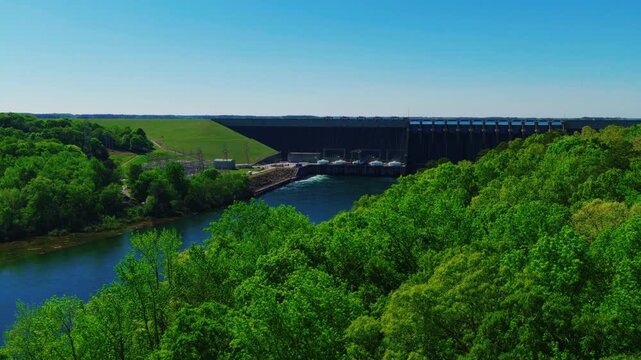 Hartwell Dam &mdash; earthen embankment, concrete spillway, four-turbine powerhouse, and electrical switchyard &mdash; with Lake Hartwell unveiled behind in spring, Georgia-Carolina border.