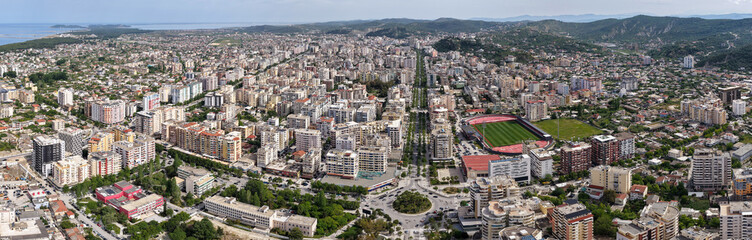 Obraz premium Wide aerial panorama of Vlora cityscape featuring a long boulevard. 