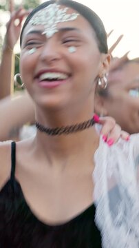 Happy, woman and dancing with friends at music festival for fun, celebration and energy at live concert. People, jump and laughing with freedom, moving rhythm and groovy event at outdoor rave party