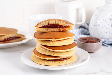 Dorayaki, classic Japanese pastry with sweet red bean paste or sweet berry jam