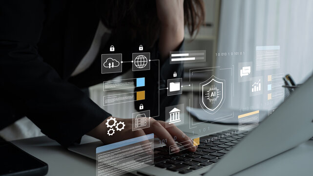 A business professional analyzes data on a laptop, surrounded by futuristic security and technology icons. This image illustrates innovation and digital transformation in today workspace. Gantry