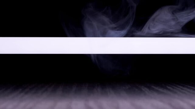 White smoke curls across a bright horizontal light beam against a black background. Concept of mystery, dramatic atmosphere, and ethereal lighting effects for abstract design.