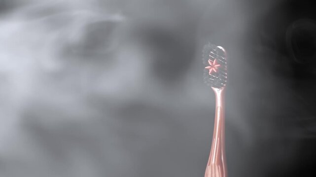 A close-up view of a rose gold toothbrush with dark bristles standing in swirling white smoke. Concept of premium oral care, modern dental hygiene, and minty fresh breath.