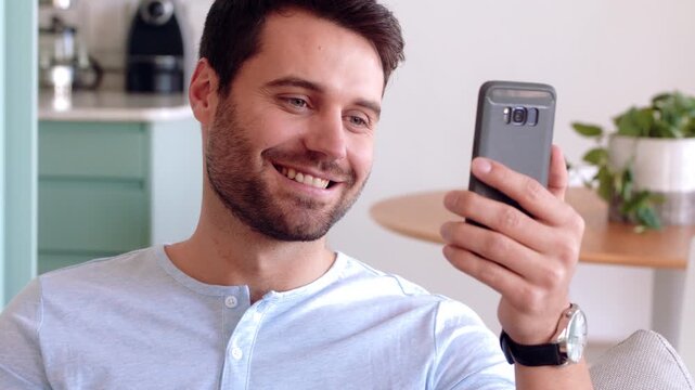 Video call, phone and man with sign language in home for communication, contact and connection. Happy, cellphone and person with I love you gesture for online conversation, chat and wave for hello