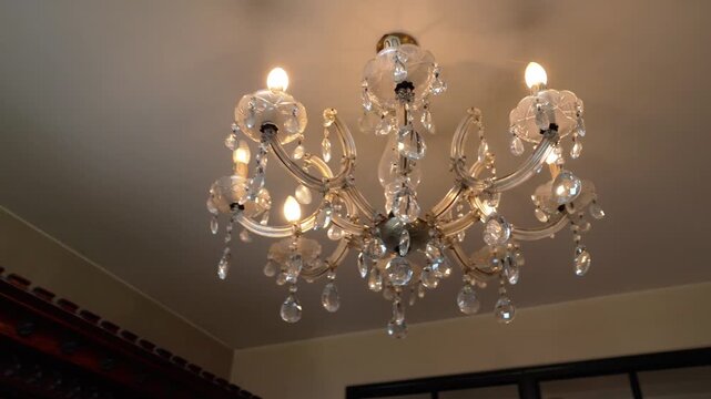 scenic ow angle rotation view of a beautiful lantern hanging from the ceiling giving off a warm light.