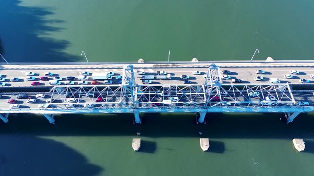 Drone aerial landscape of car and truck traffic traveling across Ryde Bridge over Parramatta River waterways near Meadowbank and Putney Sydney city NSW Australia transport and urban infrastructure