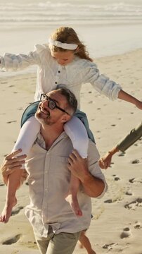 Family, father and girl on shoulder at beach with smile, airplane and bonding on vacation in summer. People, children and parents with connection, happy and holding hands with walk on seaside holiday