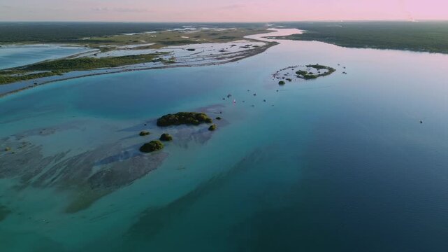 Panoramic aerial shot of Isla de los Pajaros and ancient stromatolites in the foreground with a vast extension of the turquoise lagoon and abstract patterns at sunset, Mexico.