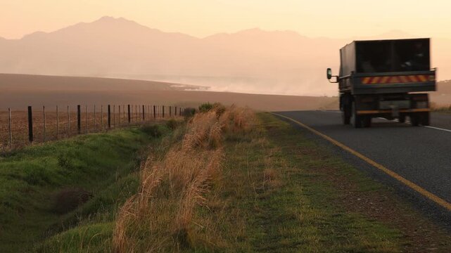 highway through farmland at sunset,, Western Cape, South Africa