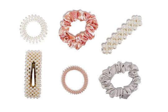 Collection of trendy silk elastic band scrunchies and hair clips on white background. Diy accessories and hairstyles concept