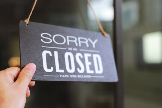 The sign is holding up the shop closing sign. closed sign on shop door. Text on cafe front or restaurant hang on door at entrance. vintage tone style. banner.