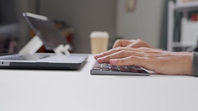 Typing on laptop home office digital workstation modern environment close-up view focus on productivity