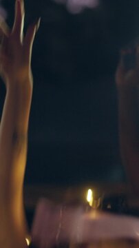 Flashlight, dance and friends with phone at festival, party and listening to music concert together. Bokeh, night and people with light for celebration, social gathering and happy for festive season