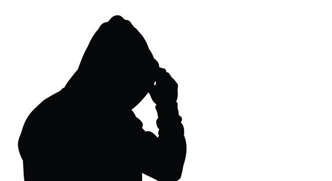 Silhouette of a mysterious person wearing a hooded sweatshirt in this striking high contrast photograph