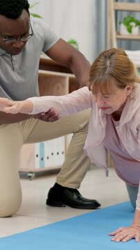 Consultation, arm and physiotherapist with senior woman in office for exercise, rehabilitation or recovery. Checkup, professional and medical worker with elderly female patient for physical therapy.