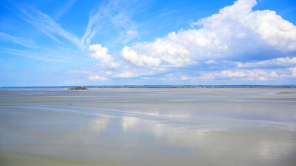 Tombelaine island rock in Mont Saint-Michel Bay, Normandy, France, Europe. Tombelaine island stands isolated on vast tidal flats in Mont Saint-Michel Bay, Normandy, France, Europe. © Iryna Shpulak