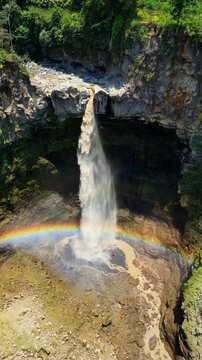 Breathtaking high angle shot of iconic Kapas Biru waterfall &ndash; Epic wild nature landscape with powerful water stream hidden in lush green jungle canopy, Java Indonesia commercial stock footage