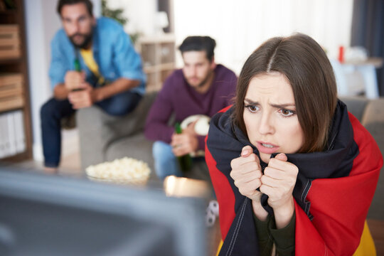 Worried German football fan watching Tv