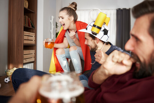 Excited football fans watching Tv