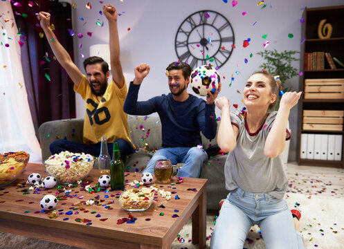 Excited fans celebrating at football party