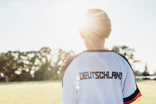 Boy wearing football shirt with Germany written on back