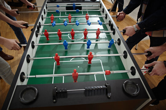 Germany, Cologne, Men and women playing table soccer