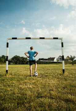 Germany, Mannheim, Teenage boy standing in goal, hands on hips