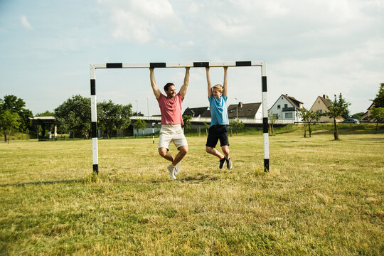 Germany, Mannheim, Father and son playing soccer