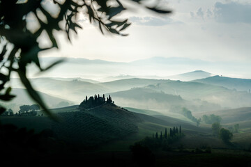 Fototapeta premium Tuscany rolling hills landscape with morning mist at sunrise, Val d'Orcia, Italy 