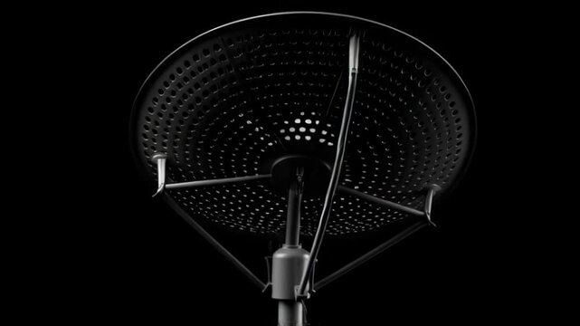 High gain satellite dish antenna silhouetted against a dark background for communication and signal reception.