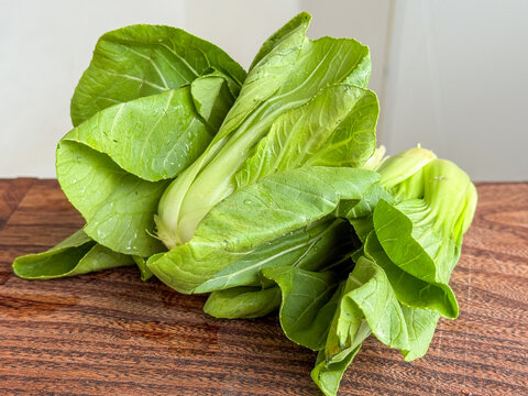 Green Vegetables On Display. Vivid Green Leafy Vegetables Showcased On Rustic Surface With Vibrant Appearance