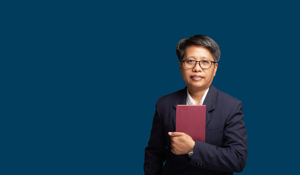 Business woman holding book in studio portrait