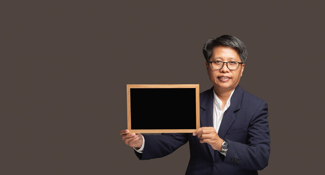 Business woman holding blank black sign board in studio